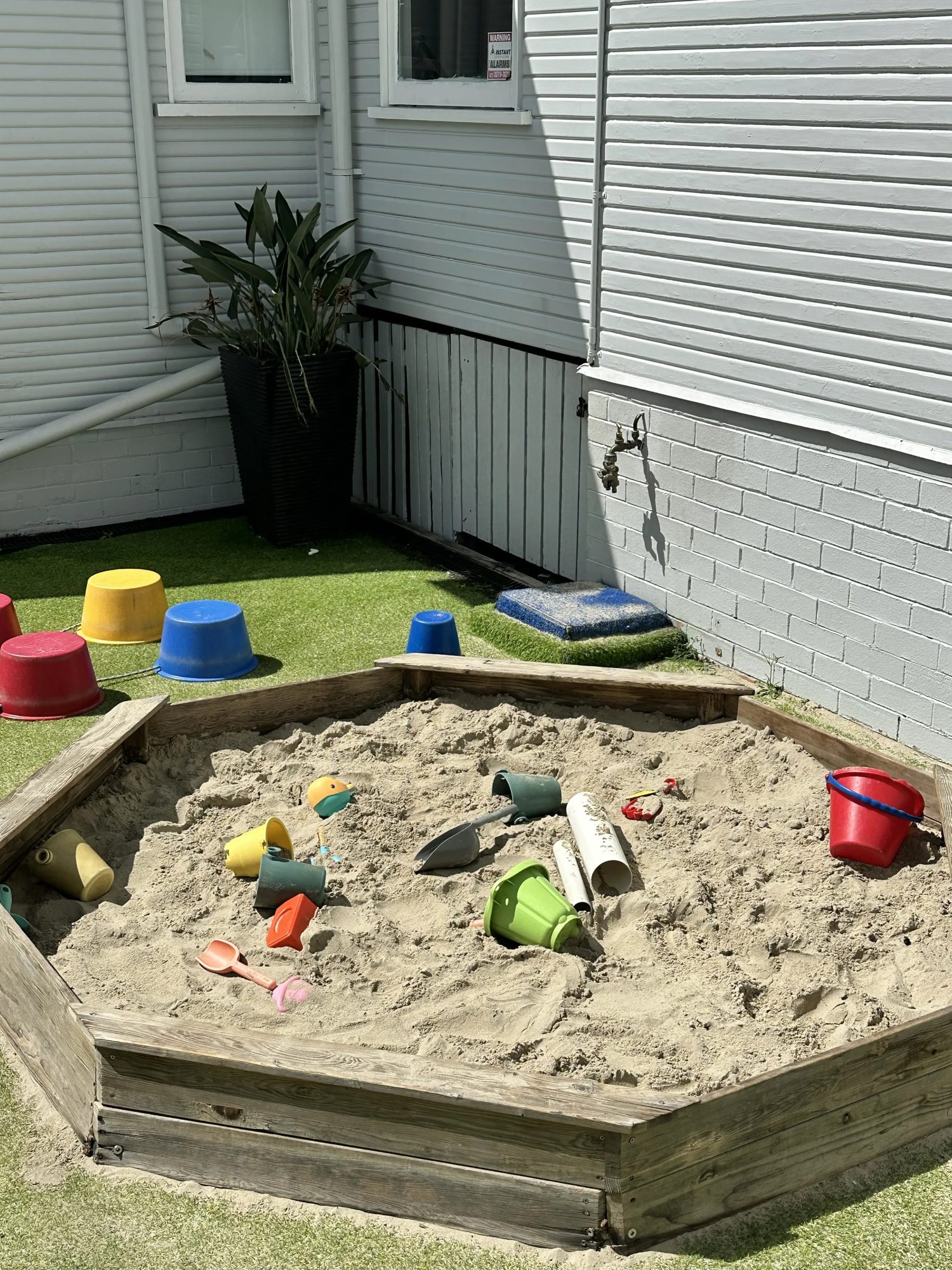 Outdoor sandpit with buckets and spades at Daisy Cottage
